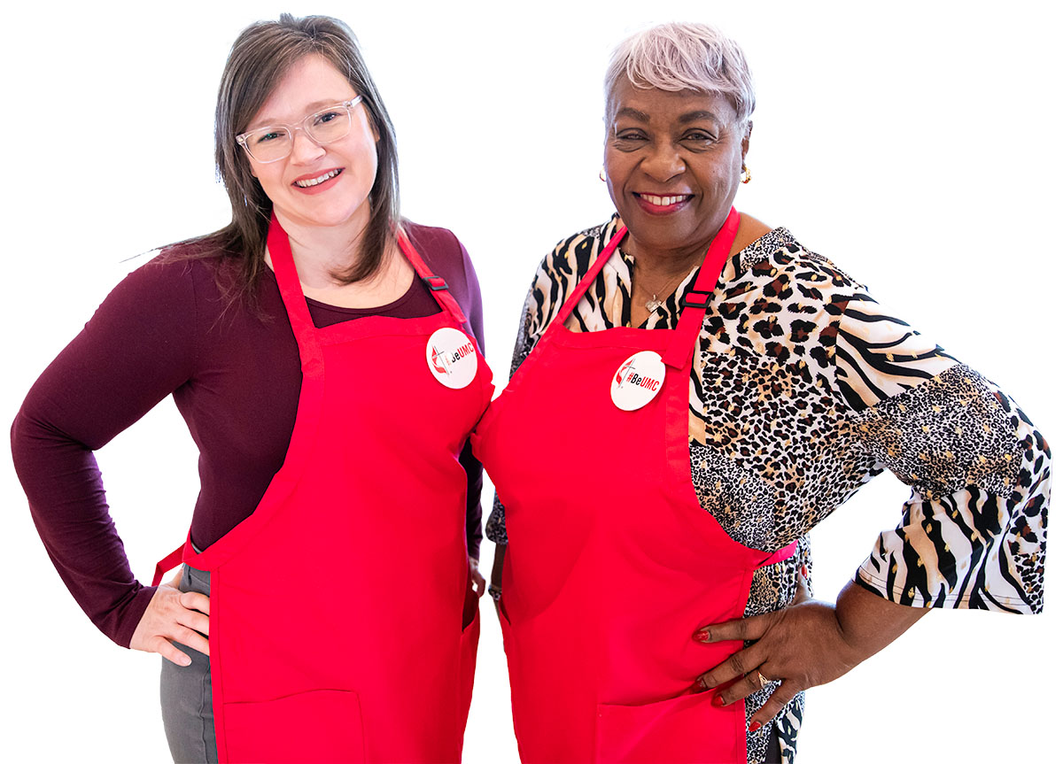 Welcome Team members wearing red aprons with #BeUMC buttons